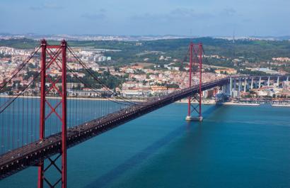 Lisbon. Image by Hivaka via Shutterstock. View of the 25 de Abril Bridge and the river in Lisbon. Image by Hivaka via Shutterstock.