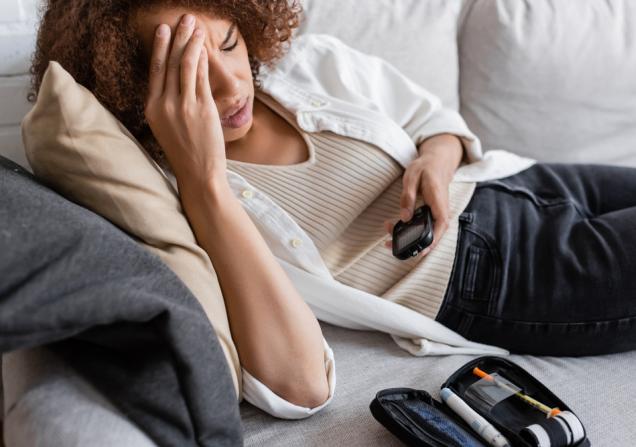 Tired woman with glucometer. Image credit: Light Field Studios via Shutterstock.
