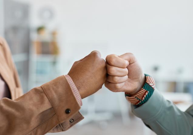 Two people doing a fist bump. Image by SeventyFour via Shutterstock