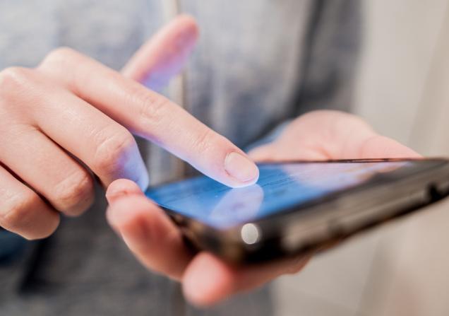 A close-up of a person using a smartphone. Image by Effective Stock Photos via Shutterstock.