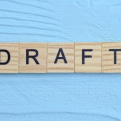 Image by Butus via Shutterstock. The word DRAFT written on wooden blocks on a pale blue background. Image by Butus via Shutterstock.