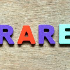 Image by Bankrx via Shutterstock. The word RARE written in colourful blocks, lying on a wooden surface. Image by Bankrx via Shutterstock.