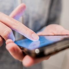 A close-up of a person using a smartphone. Image by Effective Stock Photos via Shutterstock.