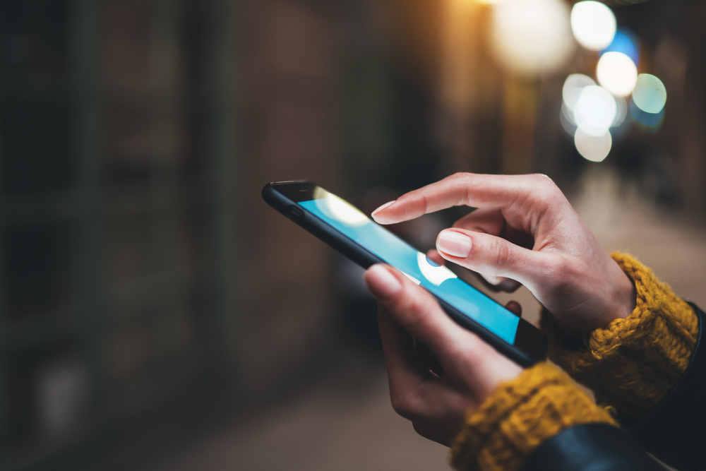 Person using a smartphone. Image by A.B.C. via Shutterstock